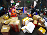 Staff work on an assembly line at the sorting center of Yancheng Yidatong Logistics Co LTD in Dafeng district of Yancheng City, East China's...