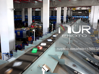 Staff work on an assembly line at the sorting center of Yancheng Yidatong Logistics Co LTD in Dafeng district of Yancheng City, East China's...