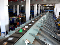 Staff work on an assembly line at the sorting center of Yancheng Yidatong Logistics Co LTD in Dafeng district of Yancheng City, East China's...