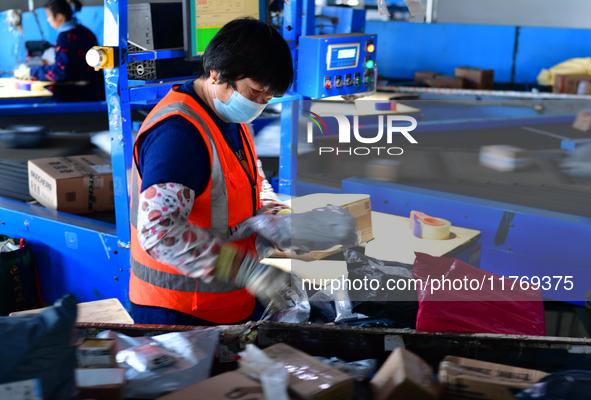 Staff work on an assembly line at the sorting center of Yancheng Yidatong Logistics Co LTD in Dafeng district of Yancheng City, East China's...