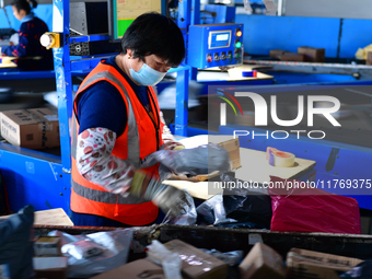 Staff work on an assembly line at the sorting center of Yancheng Yidatong Logistics Co LTD in Dafeng district of Yancheng City, East China's...