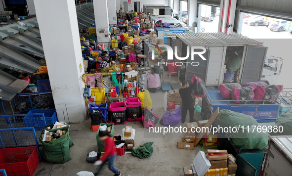 Staff work on an assembly line at the sorting center of Yancheng Yidatong Logistics Co LTD in Dafeng district of Yancheng City, East China's...