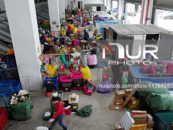 Staff work on an assembly line at the sorting center of Yancheng Yidatong Logistics Co LTD in Dafeng district of Yancheng City, East China's...