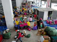 Staff work on an assembly line at the sorting center of Yancheng Yidatong Logistics Co LTD in Dafeng district of Yancheng City, East China's...