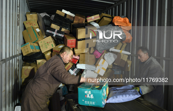 Staff work on an assembly line at the sorting center of Yancheng Yidatong Logistics Co LTD in Dafeng district of Yancheng City, East China's...