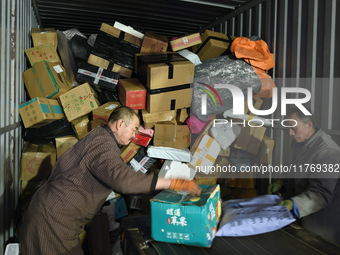 Staff work on an assembly line at the sorting center of Yancheng Yidatong Logistics Co LTD in Dafeng district of Yancheng City, East China's...