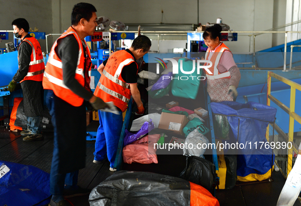 Staff work on an assembly line at the sorting center of Yancheng Yidatong Logistics Co LTD in Dafeng district of Yancheng City, East China's...