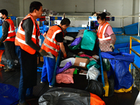 Staff work on an assembly line at the sorting center of Yancheng Yidatong Logistics Co LTD in Dafeng district of Yancheng City, East China's...