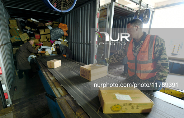 Staff work on an assembly line at the sorting center of Yancheng Yidatong Logistics Co LTD in Dafeng district of Yancheng City, East China's...