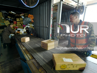 Staff work on an assembly line at the sorting center of Yancheng Yidatong Logistics Co LTD in Dafeng district of Yancheng City, East China's...