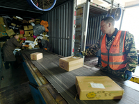 Staff work on an assembly line at the sorting center of Yancheng Yidatong Logistics Co LTD in Dafeng district of Yancheng City, East China's...