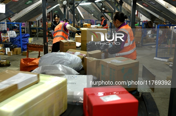 Staff work on an assembly line at the sorting center of Yancheng Yidatong Logistics Co LTD in Dafeng district of Yancheng City, East China's...