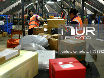 Staff work on an assembly line at the sorting center of Yancheng Yidatong Logistics Co LTD in Dafeng district of Yancheng City, East China's...