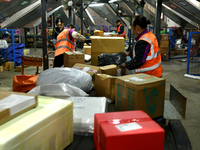 Staff work on an assembly line at the sorting center of Yancheng Yidatong Logistics Co LTD in Dafeng district of Yancheng City, East China's...