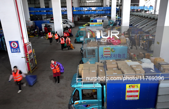 Staff work on an assembly line at the sorting center of Yancheng Yidatong Logistics Co LTD in Dafeng district of Yancheng City, East China's...