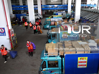 Staff work on an assembly line at the sorting center of Yancheng Yidatong Logistics Co LTD in Dafeng district of Yancheng City, East China's...