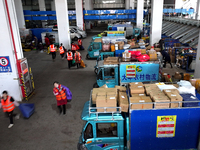 Staff work on an assembly line at the sorting center of Yancheng Yidatong Logistics Co LTD in Dafeng district of Yancheng City, East China's...