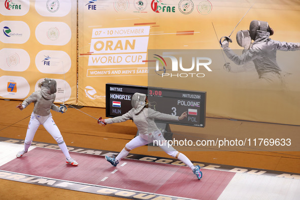 Hungarian Spiesz Anna (left) faces Polish Lenkiewicz Zuzanna (right) during the female saber team final at the 2024 Fencing World Cup in Ora...