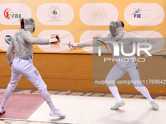 Iranian Baher Arasbaran Farzad (left) confronts Ha Hansol of South Korea (right) during the final of the Male Saber Team event at the 2024 F...