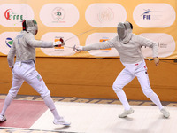 Iranian Baher Arasbaran Farzad (left) confronts Ha Hansol of South Korea (right) during the final of the Male Saber Team event at the 2024 F...