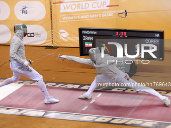 Iranian Baher Arasbaran Farzad (left) confronts Ha Hansol of South Korea (right) during the final of the Male Saber Team event at the 2024 F...