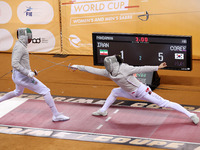 Iranian Baher Arasbaran Farzad (left) confronts Ha Hansol of South Korea (right) during the final of the Male Saber Team event at the 2024 F...