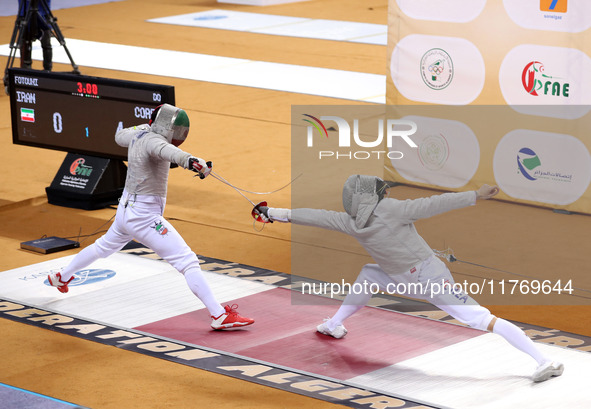 Iranian Baher Arasbaran Farzad (left) confronts Ha Hansol of South Korea (right) during the final of the Male Saber Team event at the 2024 F...