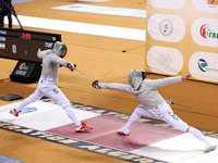 Iranian Baher Arasbaran Farzad (left) confronts Ha Hansol of South Korea (right) during the final of the Male Saber Team event at the 2024 F...