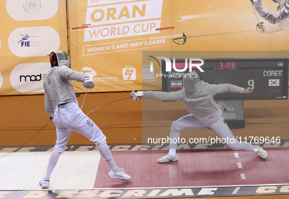 Iranian Baher Arasbaran Farzad (left) confronts Ha Hansol of South Korea (right) during the final of the Male Saber Team event at the 2024 F...