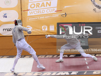 Iranian Baher Arasbaran Farzad (left) confronts Ha Hansol of South Korea (right) during the final of the Male Saber Team event at the 2024 F...