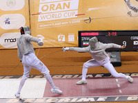 Iranian Baher Arasbaran Farzad (left) confronts Ha Hansol of South Korea (right) during the final of the Male Saber Team event at the 2024 F...