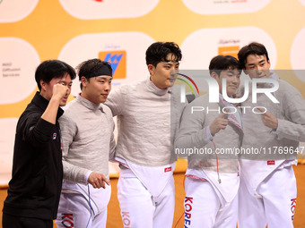 The South Korea men's saber team reacts after winning first place during the 2024 Fencing World Cup in Oran, Algeria, on November 10, 2024....