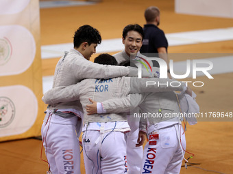 The South Korea men's saber team reacts after winning first place during the 2024 Fencing World Cup in Oran, Algeria, on November 10, 2024....