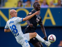 Jon Guridi of Deportivo Alaves competes for the ball with Gueye of Villarreal CF during the LaLiga EA Sports match between Villarreal CF and...