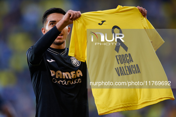 Ilias Akhomach of Villarreal CF displays a t-shirt supporting the victims of the Valencia floodings after scoring the team's first goal duri...