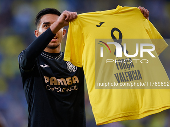 Ilias Akhomach of Villarreal CF displays a t-shirt supporting the victims of the Valencia floodings after scoring the team's first goal duri...