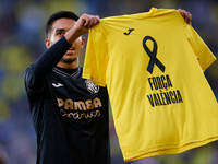 Ilias Akhomach of Villarreal CF displays a t-shirt supporting the victims of the Valencia floodings after scoring the team's first goal duri...