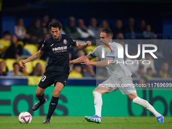 Dani Parejo of Villarreal CF competes for the ball with Kike Garcia of Deportivo Alaves during the LaLiga EA Sports match between Villarreal...