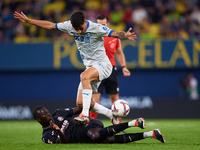 Carlos Martin of Deportivo Alaves competes for the ball with Gueye of Villarreal CF during the LaLiga EA Sports match between Villarreal CF...