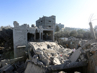 Palestinians gather on the rubble of a house destroyed in an Israeli strike at the Nuseirat refugee camp in the central Gaza Strip on Novemb...