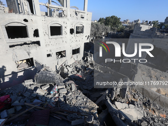 Palestinians gather on the rubble of a house destroyed in an Israeli strike at the Nuseirat refugee camp in the central Gaza Strip on Novemb...