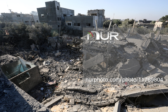 Palestinians gather on the rubble of a house destroyed in an Israeli strike at the Nuseirat refugee camp in the central Gaza Strip on Novemb...