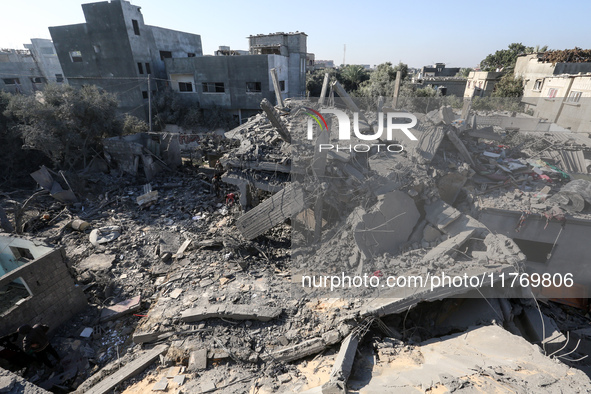 Palestinians gather on the rubble of a house destroyed in an Israeli strike at the Nuseirat refugee camp in the central Gaza Strip on Novemb...