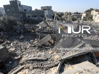 Palestinians gather on the rubble of a house destroyed in an Israeli strike at the Nuseirat refugee camp in the central Gaza Strip on Novemb...