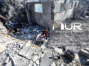 A Palestinian boy walks on the rubble of a house destroyed in an Israeli strike at the Nuseirat refugee camp in the central Gaza Strip on No...