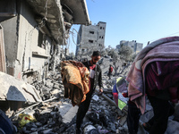 Palestinians gather on the rubble of a house destroyed in an Israeli strike at the Nuseirat refugee camp in the central Gaza Strip on Novemb...