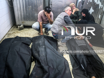 People react next to the bodies of Palestinians killed in an Israeli airstrike at the Al-Aqsa Martyrs Hospital in Deir al-Balah, central Gaz...