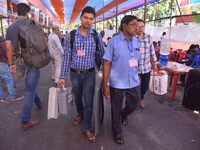 Officials carry Electronic Voting Machines (EVM) to their polling stations on the eve of Assam state assembly by-elections in Nagaon Distric...