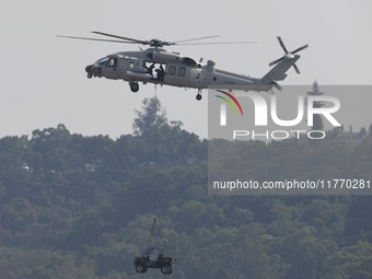 A Chinese Navy ship-borne helicopter Z-20 performs a flight demonstration at the Zhuhai Air Show in Zhuhai, Guangdong province, China, on No...