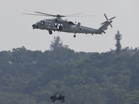 A Chinese Navy ship-borne helicopter Z-20 performs a flight demonstration at the Zhuhai Air Show in Zhuhai, Guangdong province, China, on No...